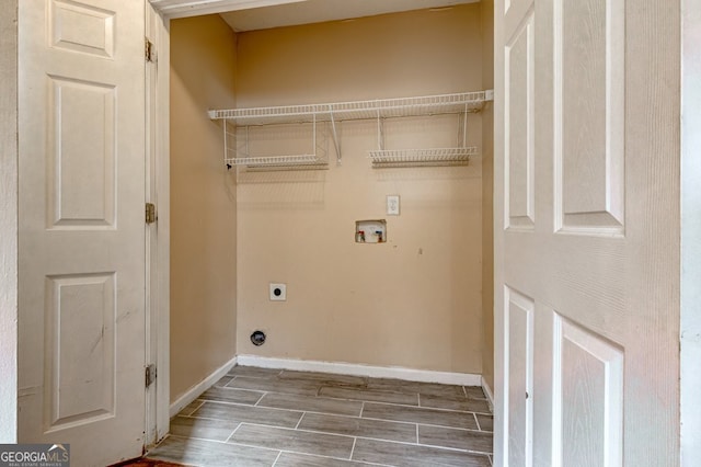 laundry area with hookup for a washing machine, hardwood / wood-style floors, and hookup for an electric dryer