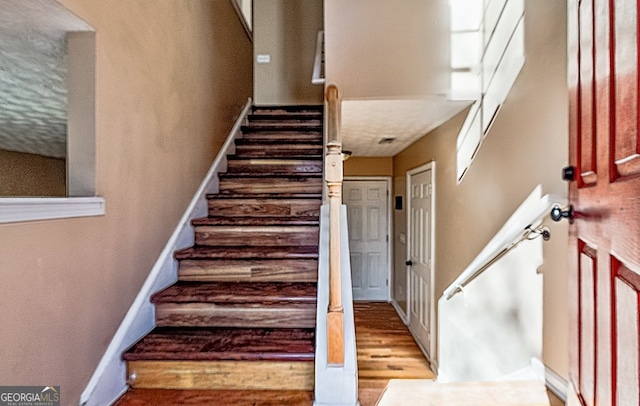 staircase featuring hardwood / wood-style floors