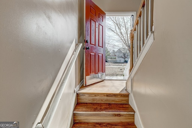 stairs with hardwood / wood-style flooring