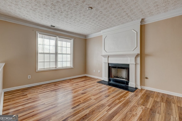 unfurnished living room featuring ornamental molding, a textured ceiling, and light wood-type flooring