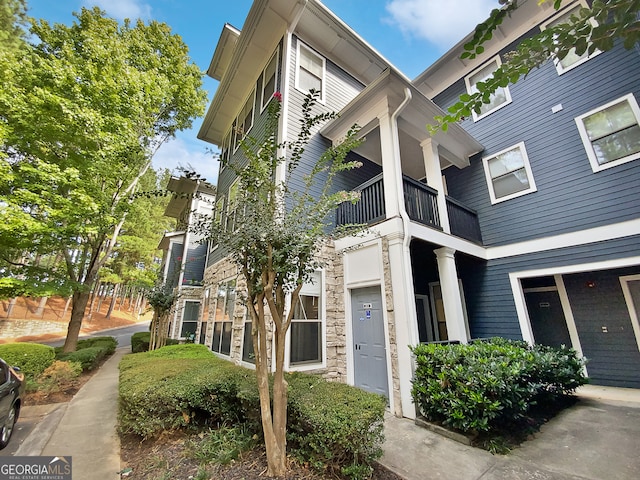 view of home's exterior with a balcony