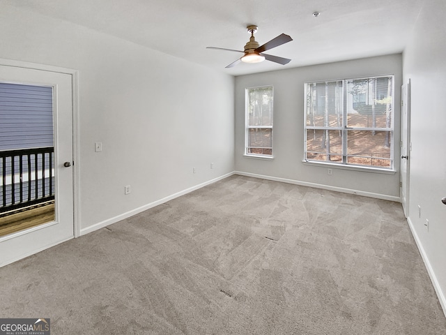 unfurnished room with ceiling fan and light carpet