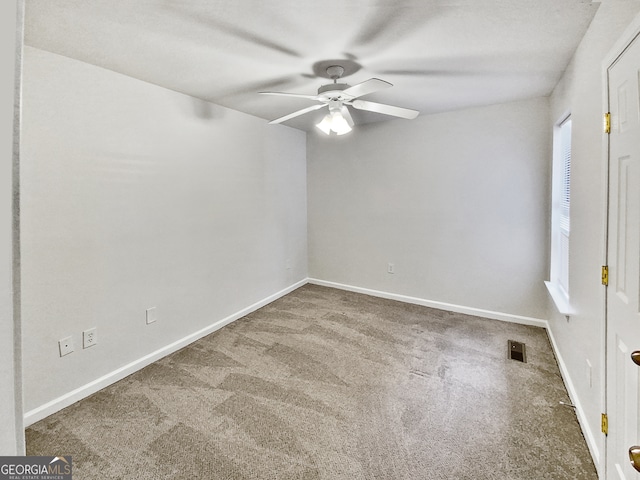 empty room featuring ceiling fan and carpet floors