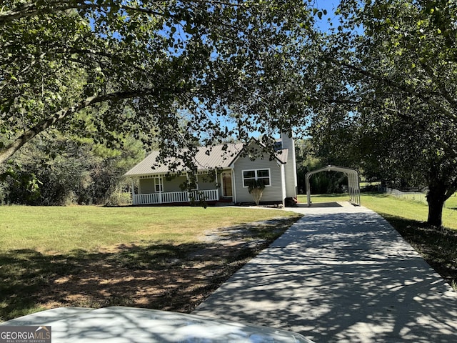 263 Hardin Rd SW, Plainville, GA 30733 - view of front facade with a detached carport, a front lawn, a chimney, concrete driveway, and a porch