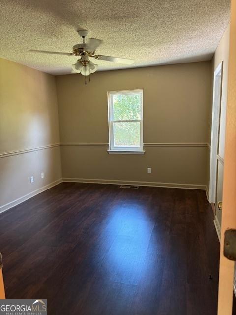 263 Hardin Rd SW, Plainville, GA 30733 - spare room with dark wood-style flooring, ceiling fan, and a textured ceiling