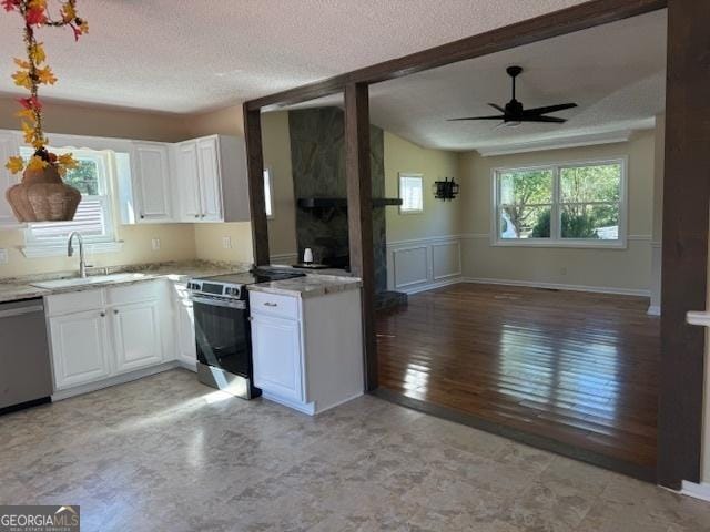 263 Hardin Rd SW, Plainville, GA 30733 - kitchen featuring appliances with stainless steel finishes, a sink, a textured ceiling, white cabinetry, and open floor plan