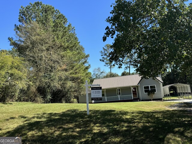 263 Hardin Rd SW, Plainville, GA 30733 - single story home with covered porch, metal roof, a detached carport, and a front lawn