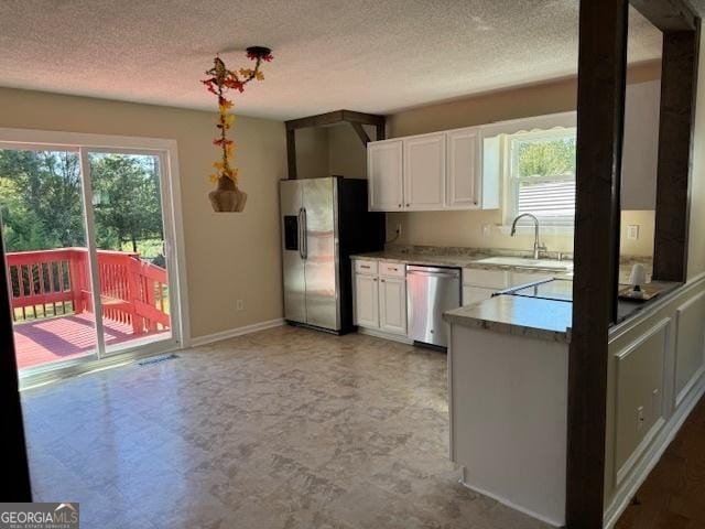 263 Hardin Rd SW, Plainville, GA 30733 - kitchen with white cabinetry, a textured ceiling, appliances with stainless steel finishes, and a sink