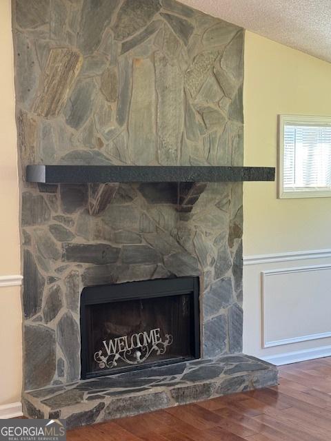 263 Hardin Rd SW, Plainville, GA 30733 - details featuring a textured ceiling, wood finished floors, and a fireplace