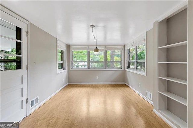 spare room featuring light hardwood / wood-style flooring