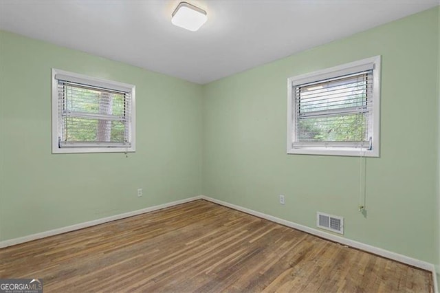 spare room featuring hardwood / wood-style flooring