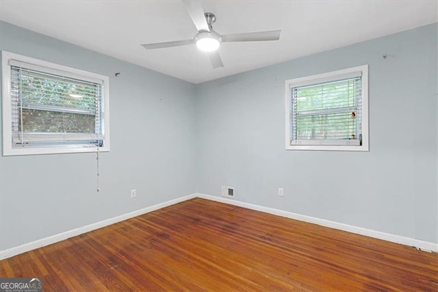 empty room featuring wood-type flooring and ceiling fan