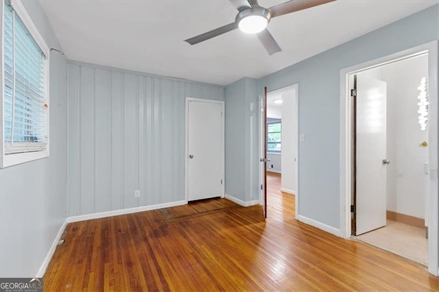 unfurnished bedroom featuring ceiling fan and hardwood / wood-style flooring