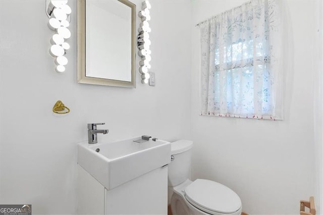 bathroom with vanity and toilet