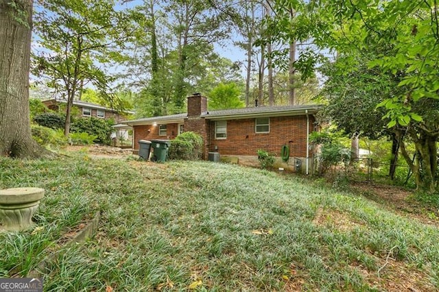 rear view of property with central AC