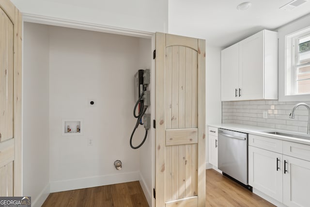 laundry area with washer hookup, light hardwood / wood-style flooring, sink, and electric dryer hookup