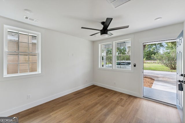 spare room featuring ceiling fan and light hardwood / wood-style flooring