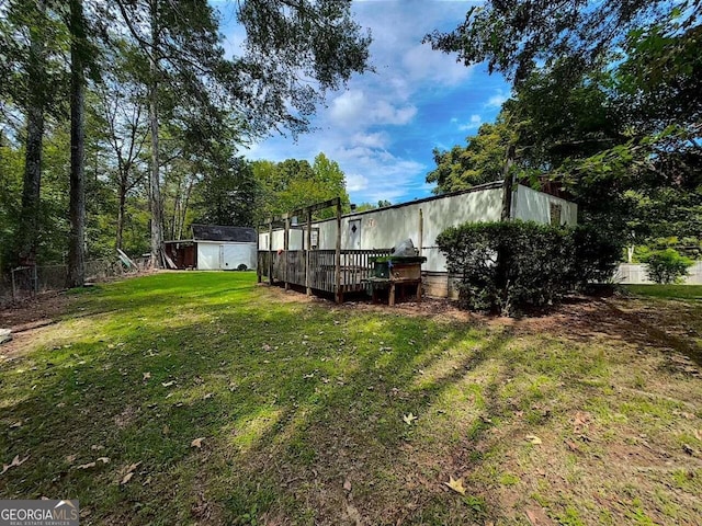 view of yard with a shed and a deck