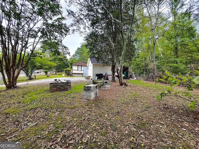 view of yard with a fire pit