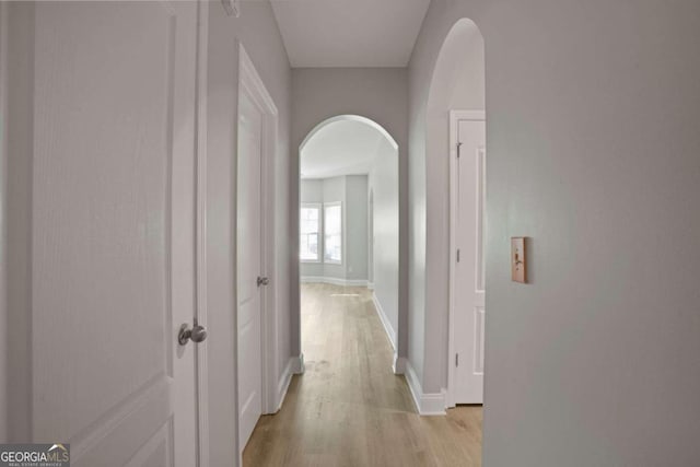 corridor with light hardwood / wood-style flooring