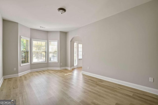 spare room with hardwood / wood-style floors