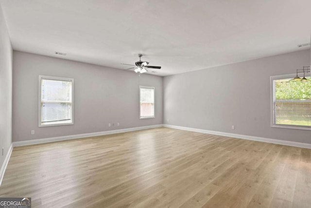 unfurnished room with light wood-type flooring and ceiling fan