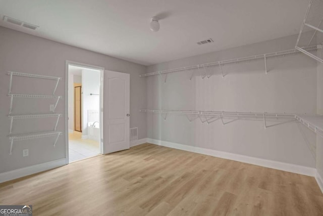 walk in closet featuring light hardwood / wood-style floors