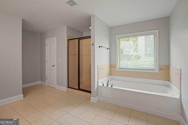 bathroom featuring tile patterned flooring and shower with separate bathtub