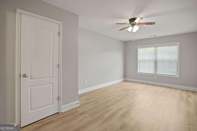 spare room with light hardwood / wood-style flooring and ceiling fan