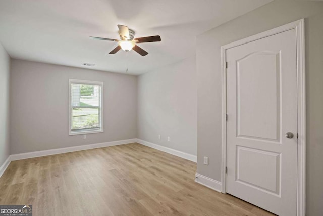 empty room featuring light wood-type flooring and ceiling fan