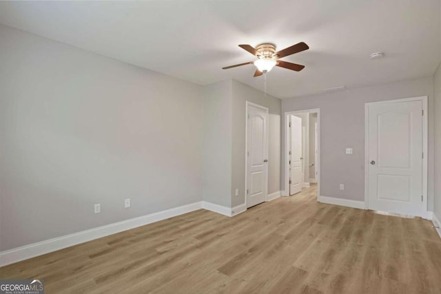 unfurnished bedroom featuring light wood-type flooring and ceiling fan