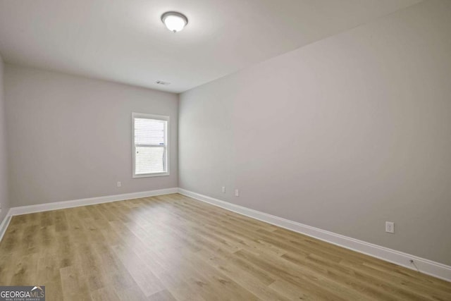 spare room featuring light hardwood / wood-style flooring