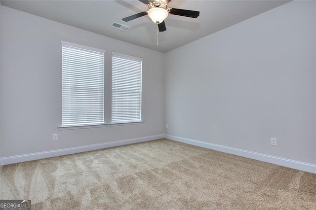 carpeted empty room featuring ceiling fan