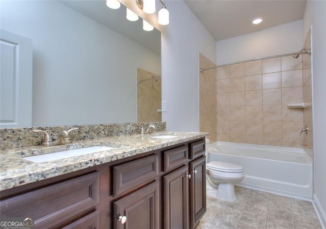 full bath with toilet, bathing tub / shower combination, double vanity, and tile patterned floors