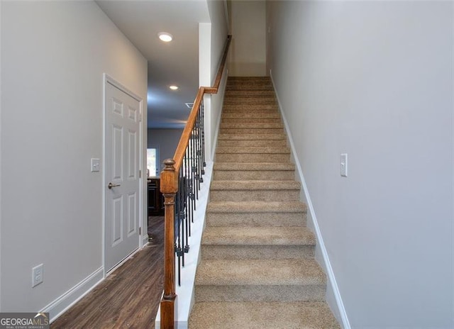 staircase with hardwood / wood-style flooring