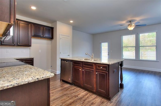 kitchen with ceiling fan, a kitchen island with sink, dishwasher, dark hardwood / wood-style floors, and light stone countertops