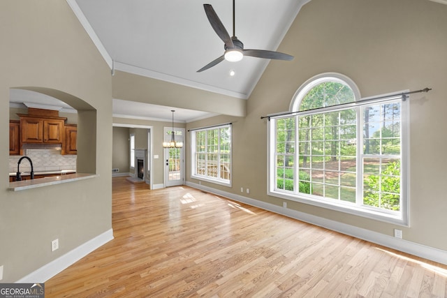 unfurnished living room featuring a healthy amount of sunlight, light hardwood / wood-style flooring, and ceiling fan