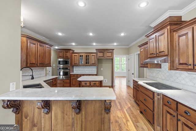 kitchen with light hardwood / wood-style flooring, appliances with stainless steel finishes, sink, kitchen peninsula, and a breakfast bar