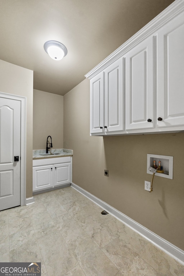 clothes washing area with washer hookup, electric dryer hookup, cabinets, and sink