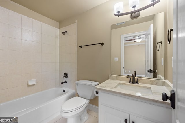 full bathroom with ceiling fan, toilet, tiled shower / bath combo, and vanity