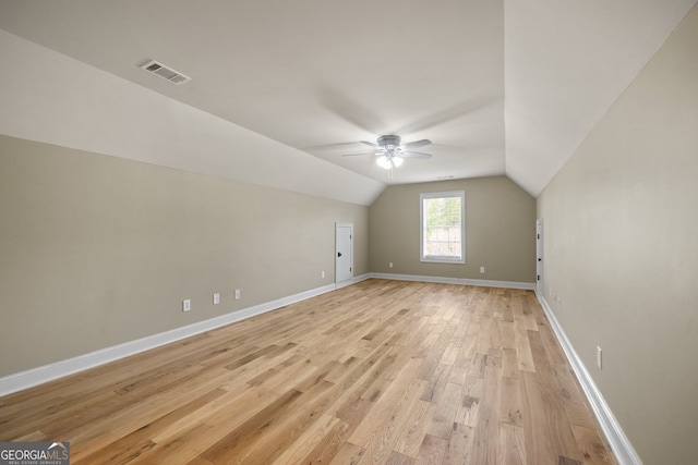 additional living space featuring lofted ceiling, ceiling fan, and light wood-type flooring