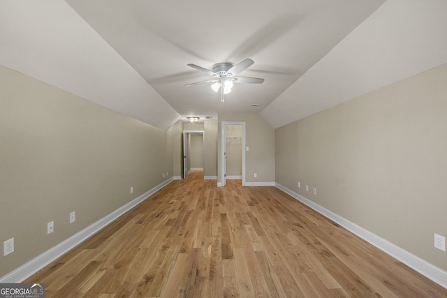 additional living space with ceiling fan, vaulted ceiling, and light hardwood / wood-style floors