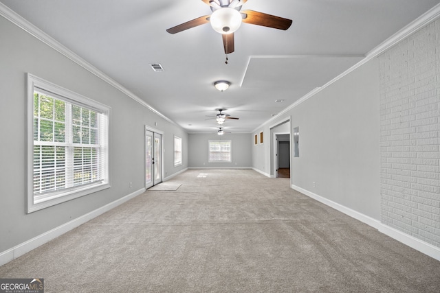 unfurnished living room with ceiling fan, ornamental molding, and light carpet