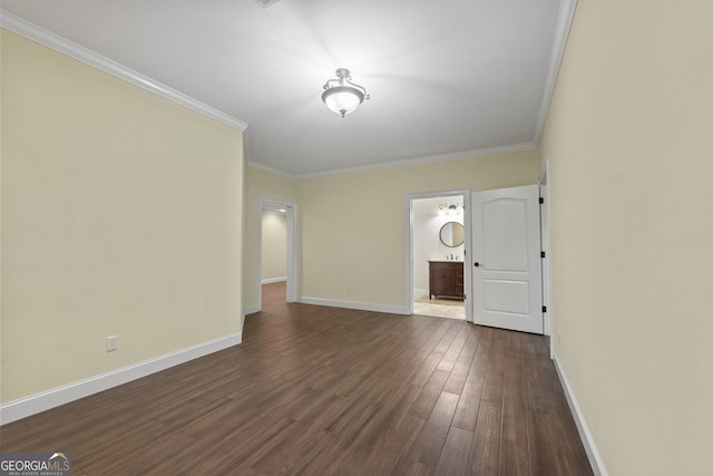 empty room with crown molding and dark hardwood / wood-style floors