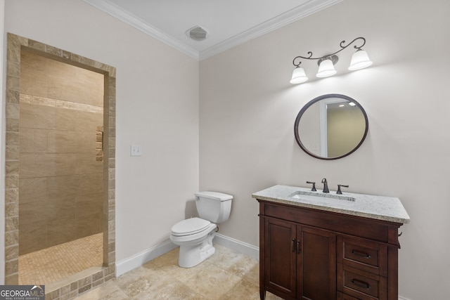 bathroom with crown molding, vanity, toilet, and tiled shower