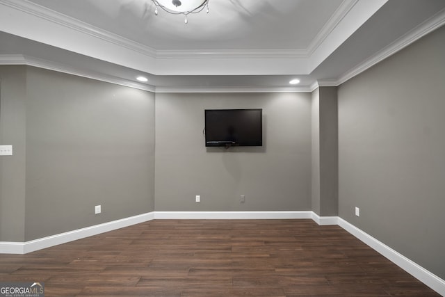 spare room featuring ornamental molding and dark hardwood / wood-style floors