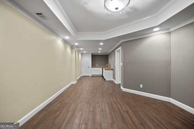 unfurnished living room with ornamental molding, sink, and dark hardwood / wood-style flooring