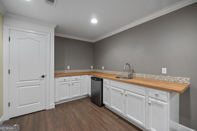 kitchen with dark hardwood / wood-style flooring, sink, wood counters, and white cabinets