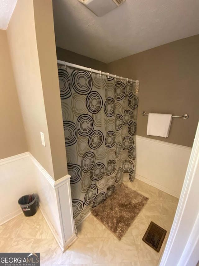 bathroom with a shower with curtain