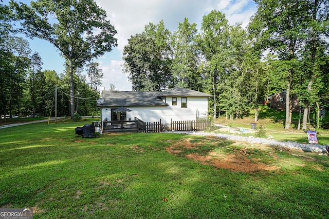 exterior space with a lawn and a wooden deck